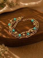 Gold tone chain beaded bracelet on an adjustable chain, laid flat