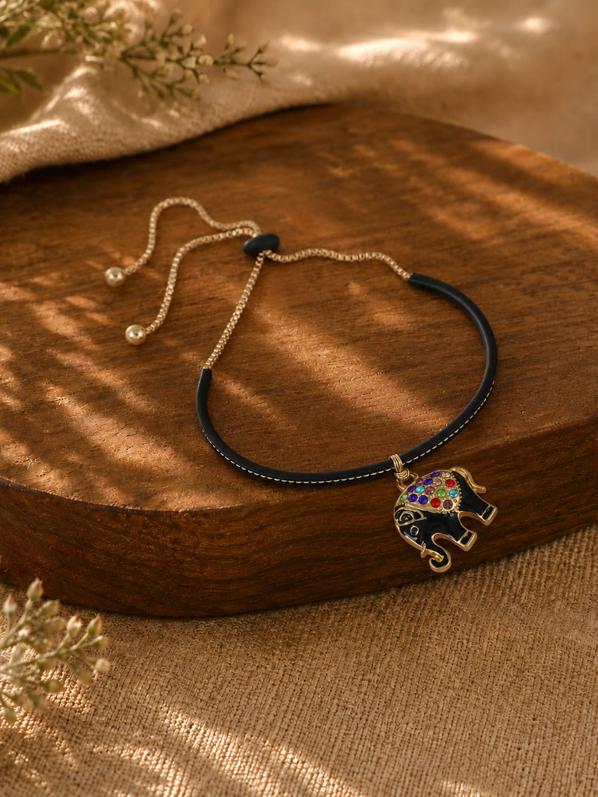 Diamond elephant pendant bracelet on a chain, laid flat