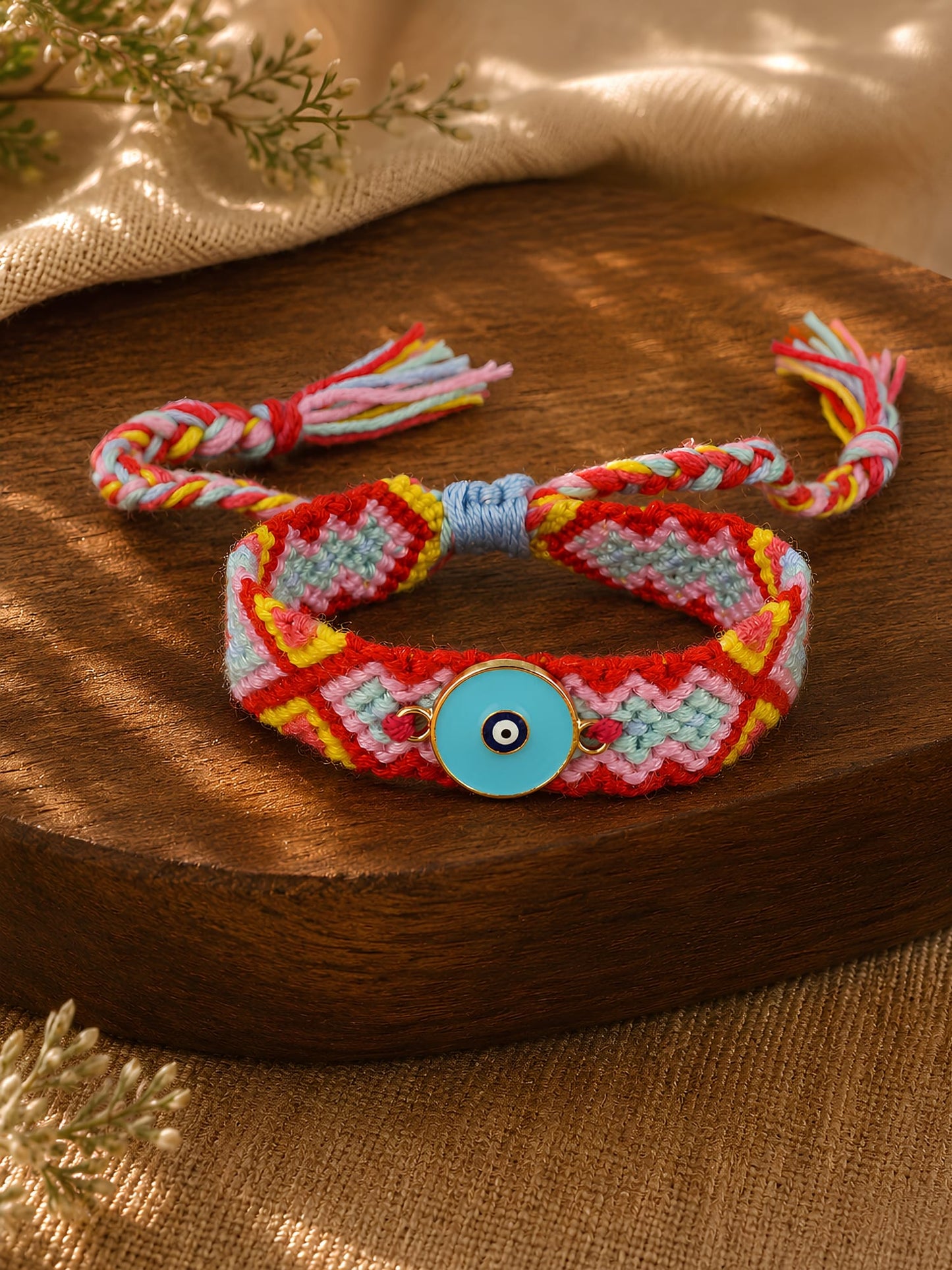 Handwoven evil eye charm bracelet, laid flat