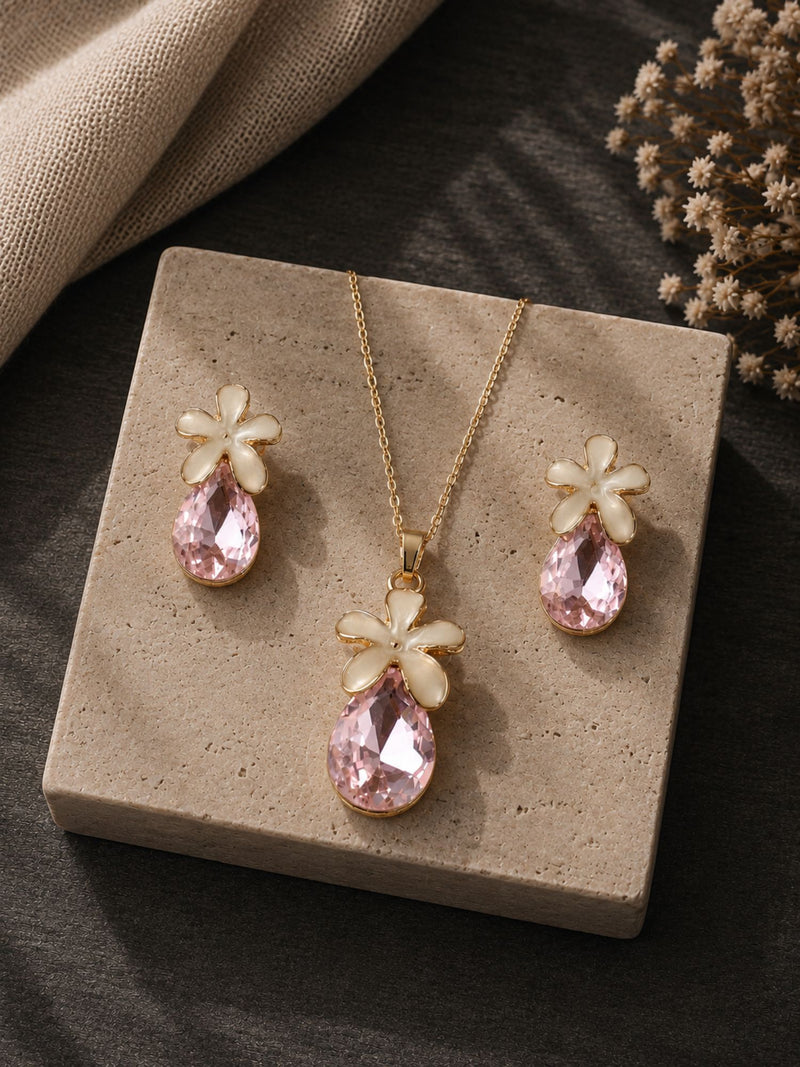 Pastel pink crystal jewellery set necklace and earrings laid flat