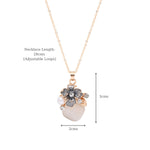 Close-up of the enamel floral charm and crystal-pearl setting on the pendant
