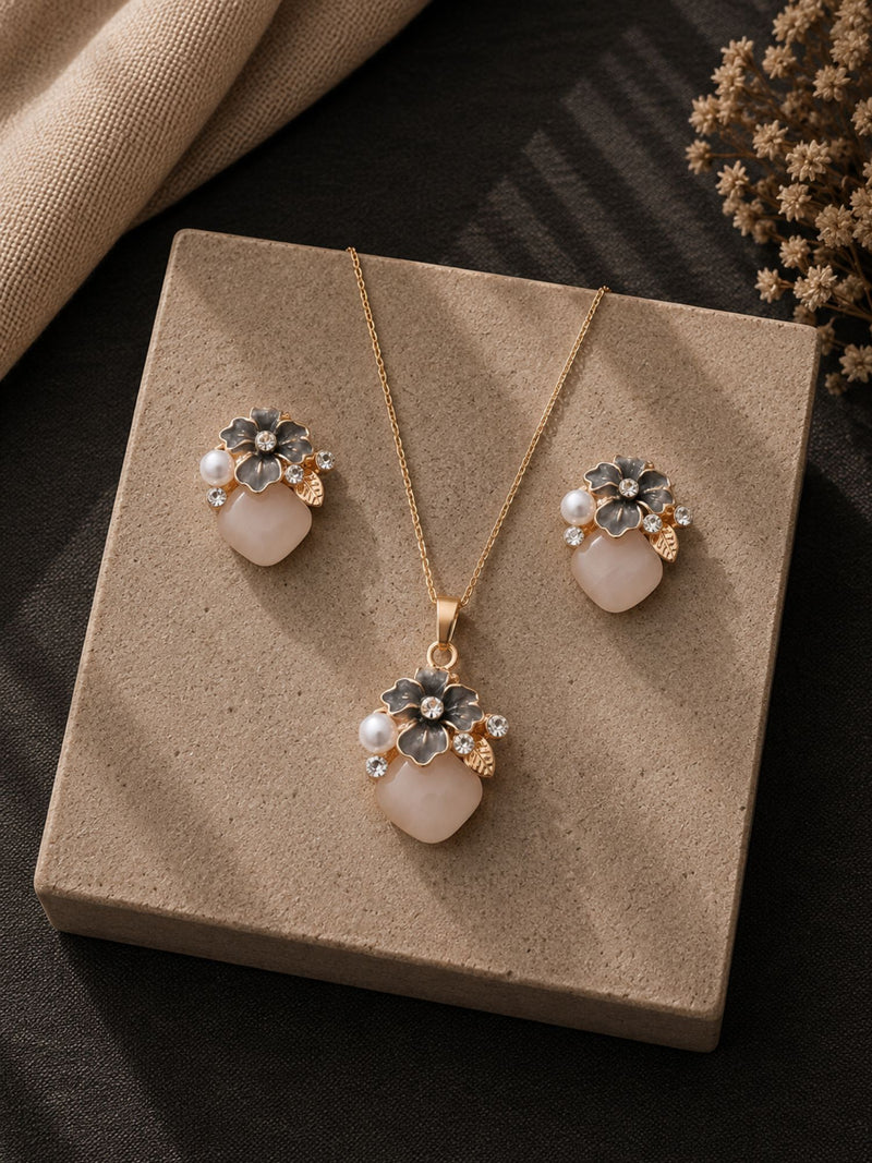 Smoky grey crystal and pearl jewellery set — necklace and earrings laid flat