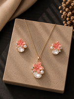 Peach crystal jewellery set — necklace and earrings laid flat