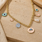 Elephant pendant necklace worn, showing drape and evil eye charms

