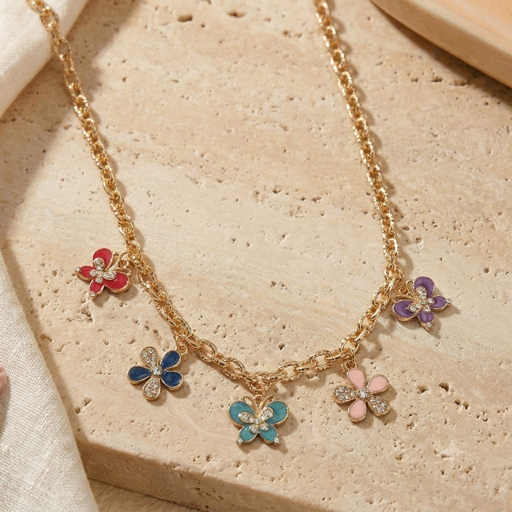 Diamond Stone butterfly and floral charm necklace on a chain, laid flat