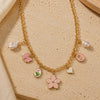 Floral charm necklace on a chain, laid flat