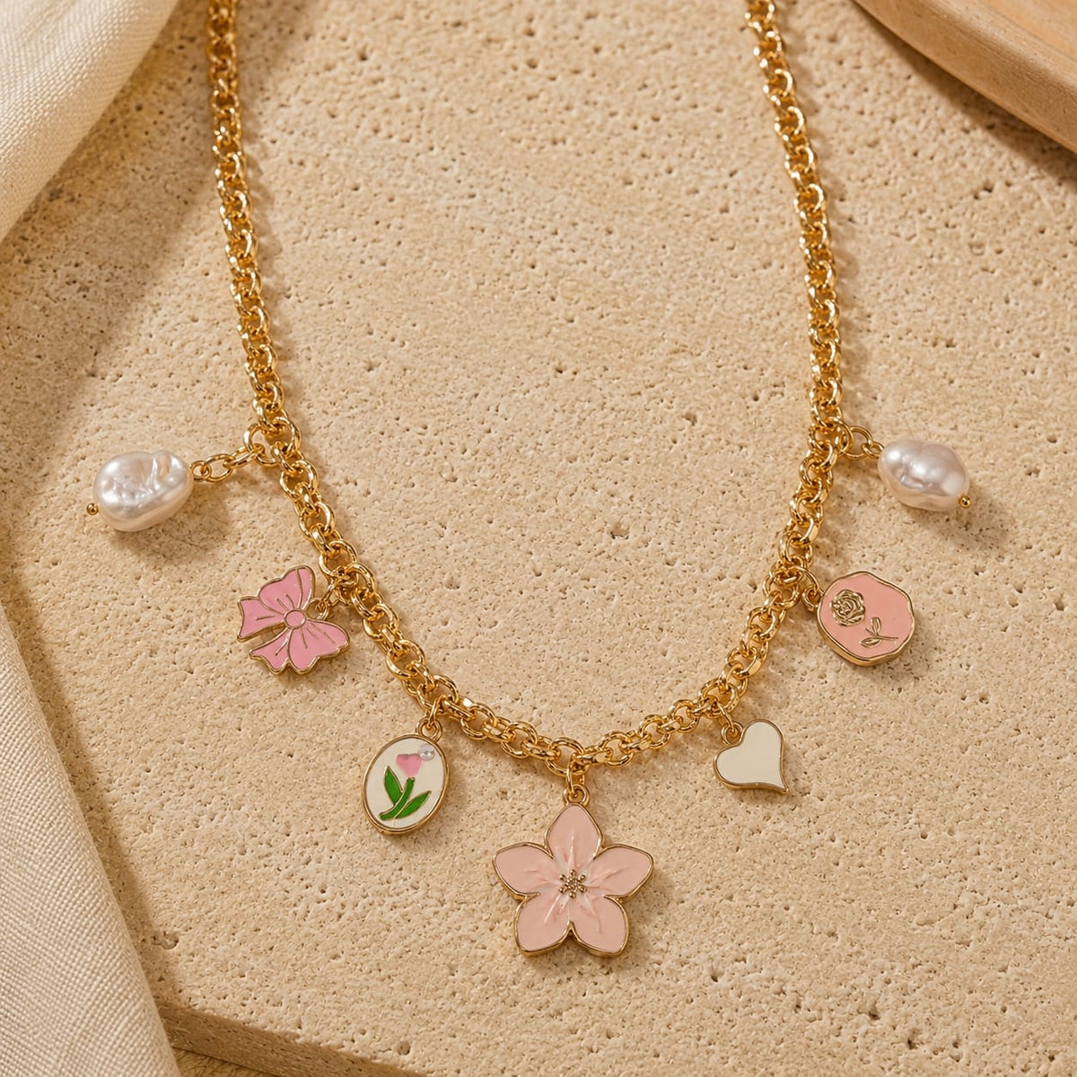 Floral charm necklace on a chain, laid flat