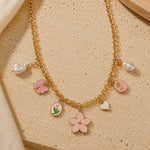 Floral charm necklace on a chain, laid flat