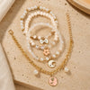Floral charm bracelet set of 4, beaded and chain styles, laid flat