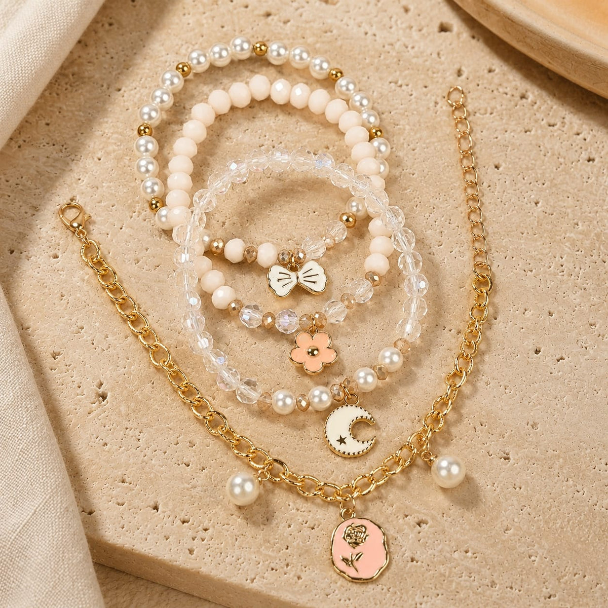 Floral charm bracelet set of 4, beaded and chain styles, laid flat