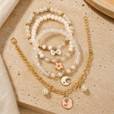 Floral charm bracelet set of 4, beaded and chain styles, laid flat