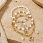 Butterfly charm bracelet set of 3, beaded and chain styles, laid flat