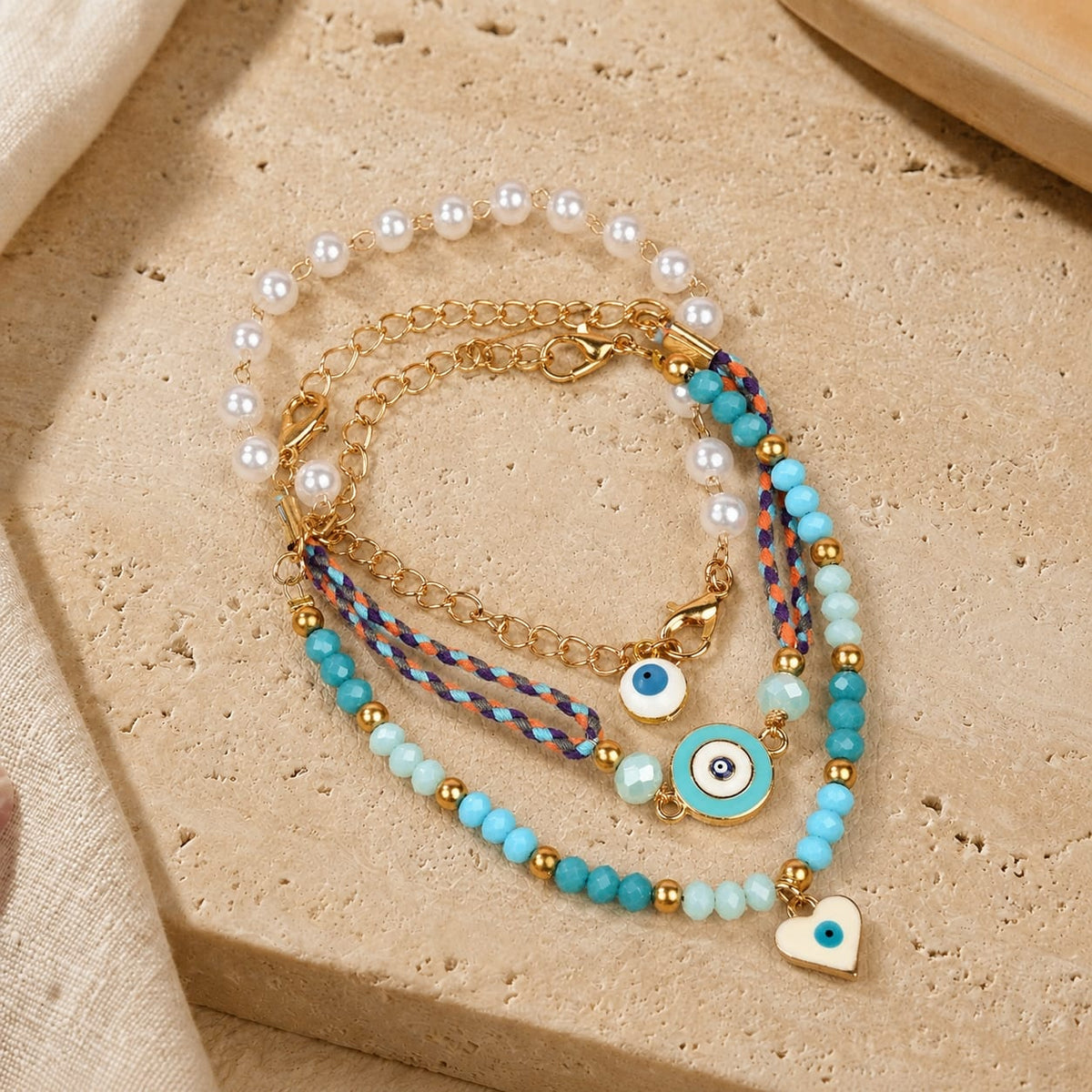 Turquoise and gold beaded Evil Eye charm bracelet set of 3, laid flat
