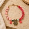 Pink ombre beaded Evil Eye Lotus charm bracelet, laid flat
