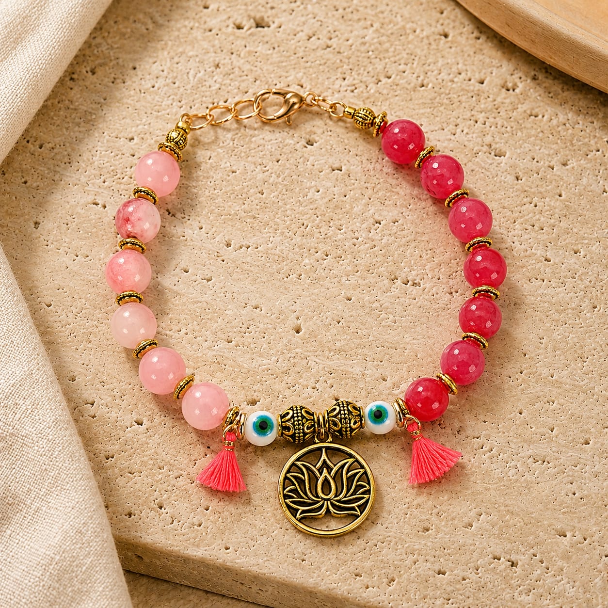 Pink ombre beaded Evil Eye Lotus charm bracelet, laid flat