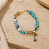 Turquoise chip bead Evil Eye charm bracelet, laid flat
