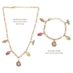 A gold-tone necklace and matching bracelet set with colorful ice cream and donut charms, shown on a white background with printed length details.