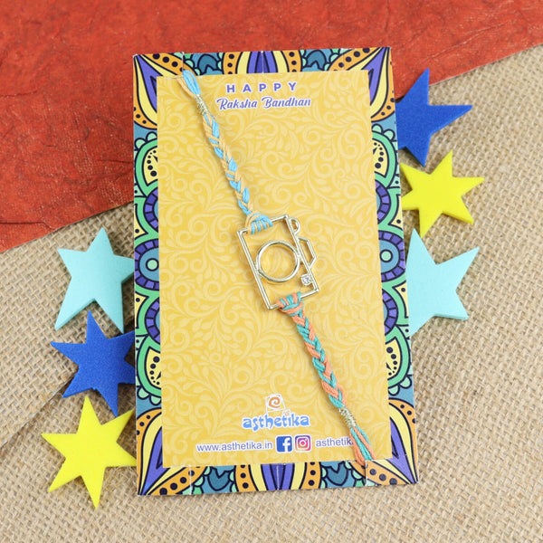 Wire Metal Camera Rakhi with Diamond Stone